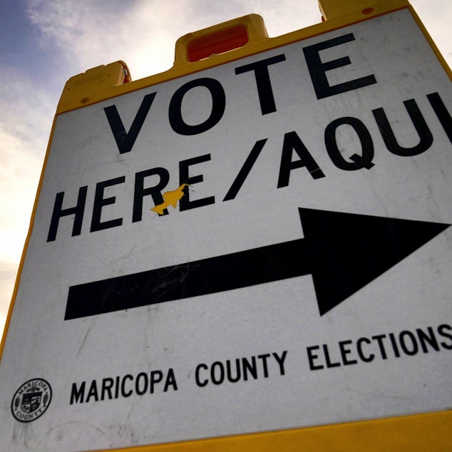 caption: In this file photo, voters deliver their ballot to a polling station in Tempe, Ariz., on Nov. 3, 2020. In the 2024 presidential preference election in Arizona, independent voters are not permitted to vote.