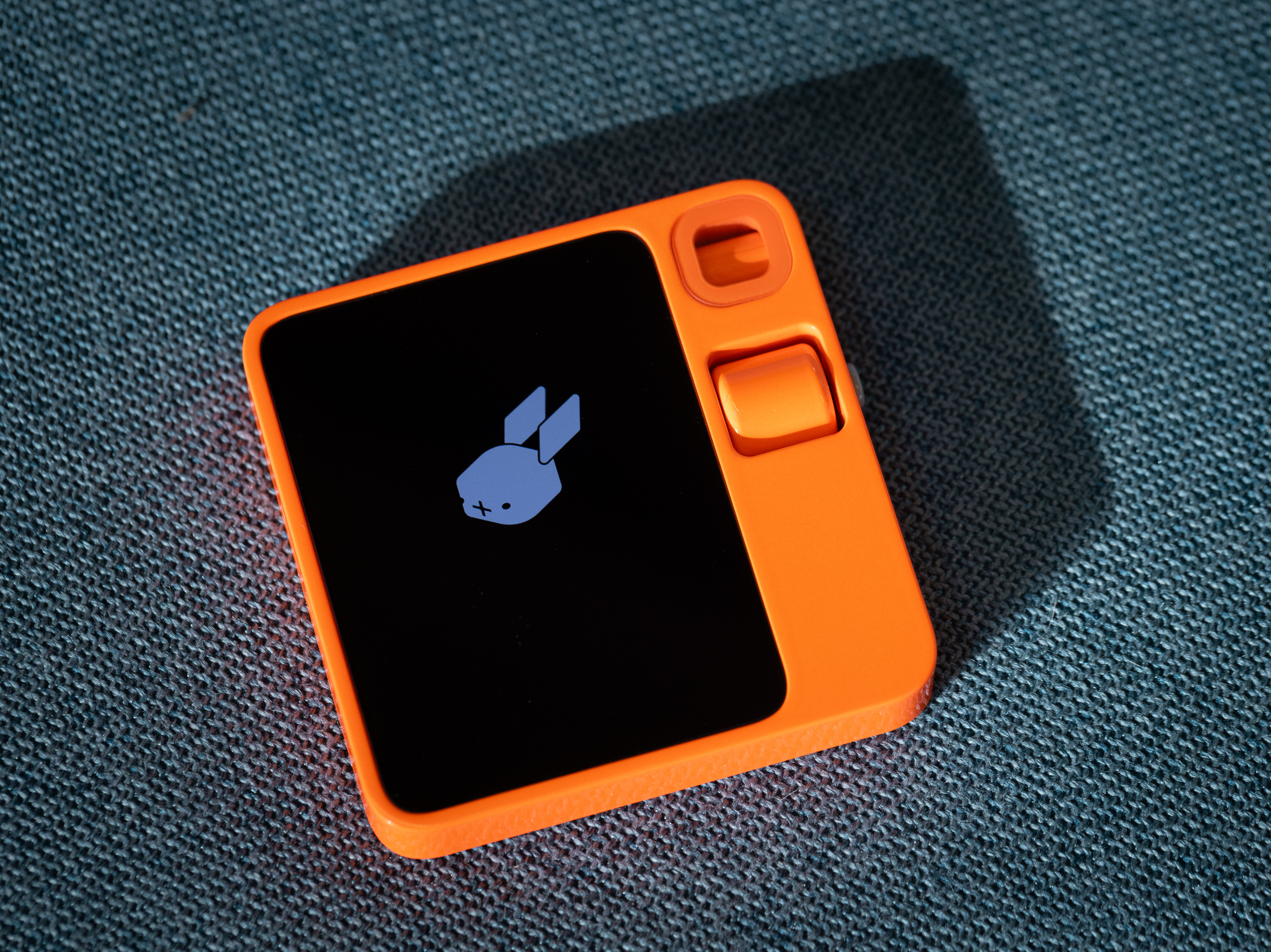 caption: The AI-powered Rabbit R1 device is seen at Rabbit Inc.'s headquarters in Santa Monica, California. The gadget is meant to serve as a personal assistant fulfilling tasks such as ordering food on DoorDash for you, calling an Uber or booking your family's vacation.