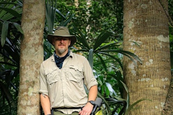 caption: Host of THE WILD Chris Morgan is ready with is microphone to record an episode in Belize. December 2020. 