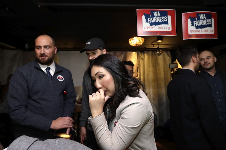 caption: Hyeok Kim, left, a chair for WA Fairness, watches for early results at an election night party for supporters of Referendum 88, Tuesday, Nov. 5, 2019, in Seattle. Voters were deciding whether one's minority status should be considered as a contributing factor in state employment, contracting and admission to public colleges and universities.
