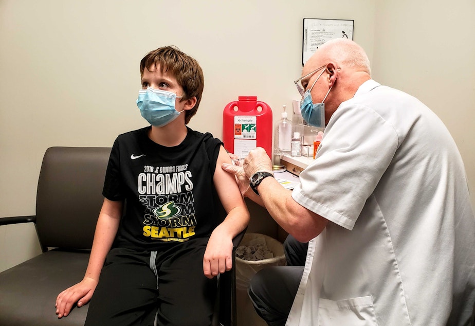 caption: Abe says now that he's vaccinated he feels safer making tackles during football with friends. Monday, November 8, 2021.