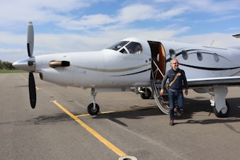 caption: KinectAir CEO Jonathan Evans disembarks from a Pilatus PC-12 aircraft in Kalispell after joining a customer's flight from Vancouver, Washington.