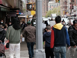 caption: People walking through a busy street in Chinatown in New York City. About 11 percent of Chinese Americans live in poverty, according to a new analysis by the Pew Research Center.