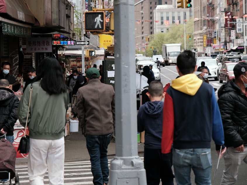 caption: People walking through a busy street in Chinatown in New York City. About 11 percent of Chinese Americans live in poverty, according to a new analysis by the Pew Research Center.