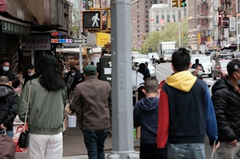 caption: People walking through a busy street in Chinatown in New York City. About 11 percent of Chinese Americans live in poverty, according to a new analysis by the Pew Research Center.