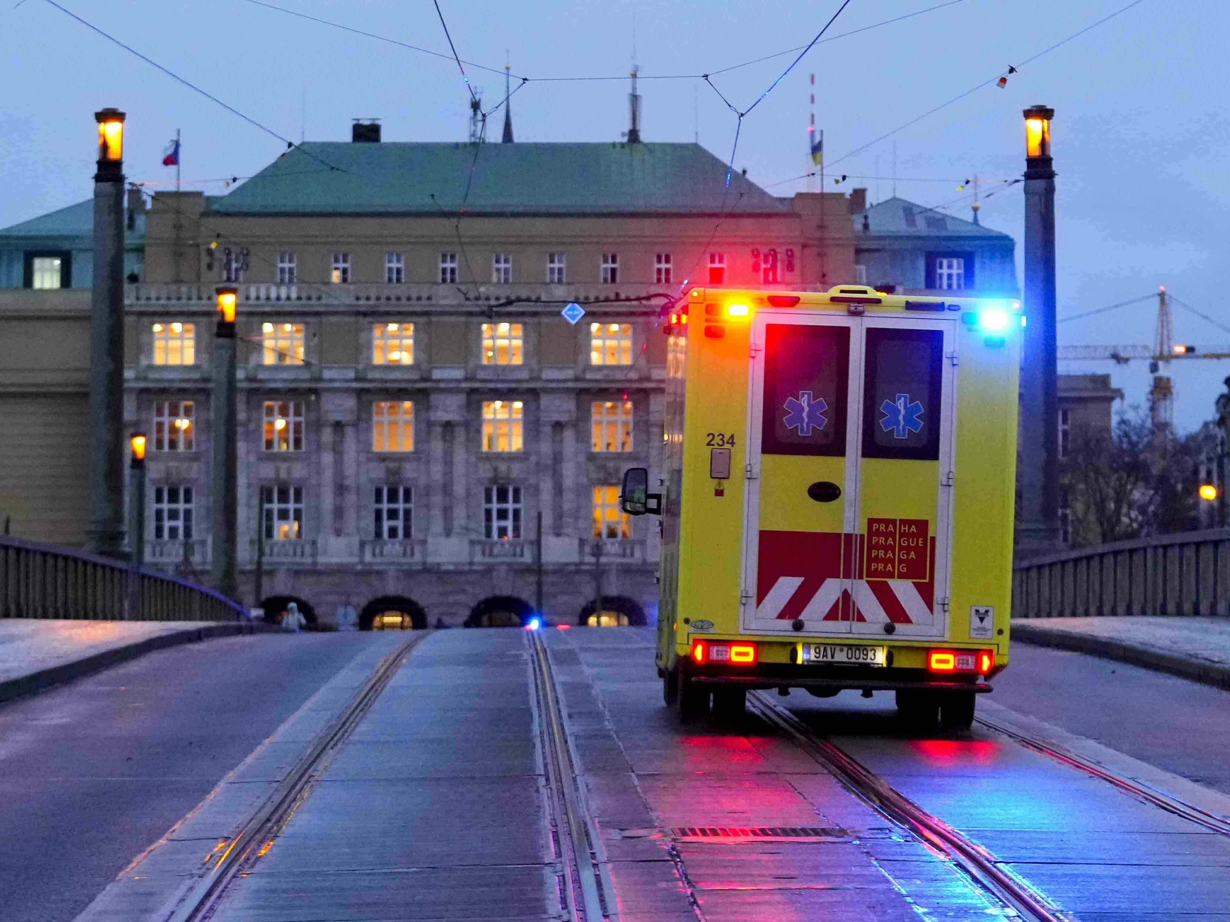 caption: An ambulance drives towards the building of Philosophical Faculty of Charles University in downtown Prague on Thursday after a deadly shooting.