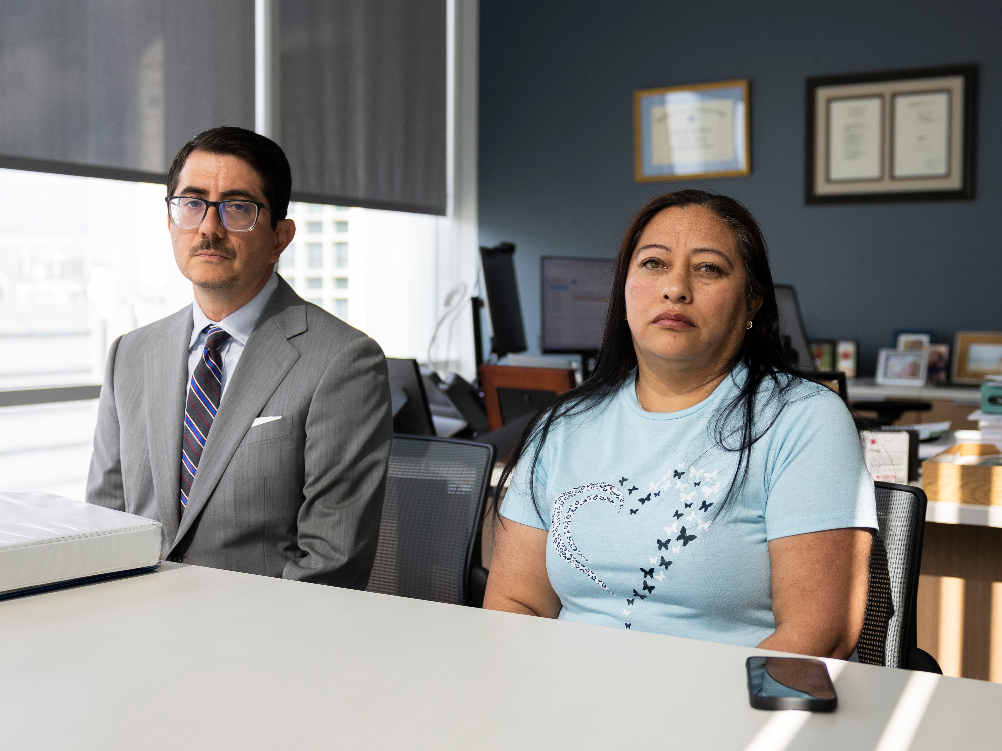 caption: Travis County District Attorney José P. Garza and Rosa Isela Batalla Morales and sit in his office. Austin-based D Guerra Construction LLC agreed to plead guilty in connection with the death of Batalla Morales' son, Juan José Galvan Batalla, who died in October 2021 when a 13-foot-deep trench caved while he was working.