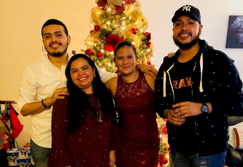 caption: Javier Maradiaga (far right) with his brother, Jason Castillo; mother, Alma Maradiaga; and sister, Dariela Moncada on Christmas Eve in 2017.