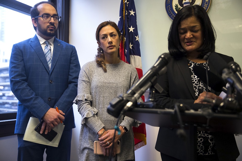 caption: Negah Hekmati, 38, center, stands with Rep. Pramila Jayapal after speaking during a press conference about her 5-hour long delay returning to the U.S. from Canada with her family, at the Congresswoman's office on Monday, January 6, 2020, in downtown Seattle. 