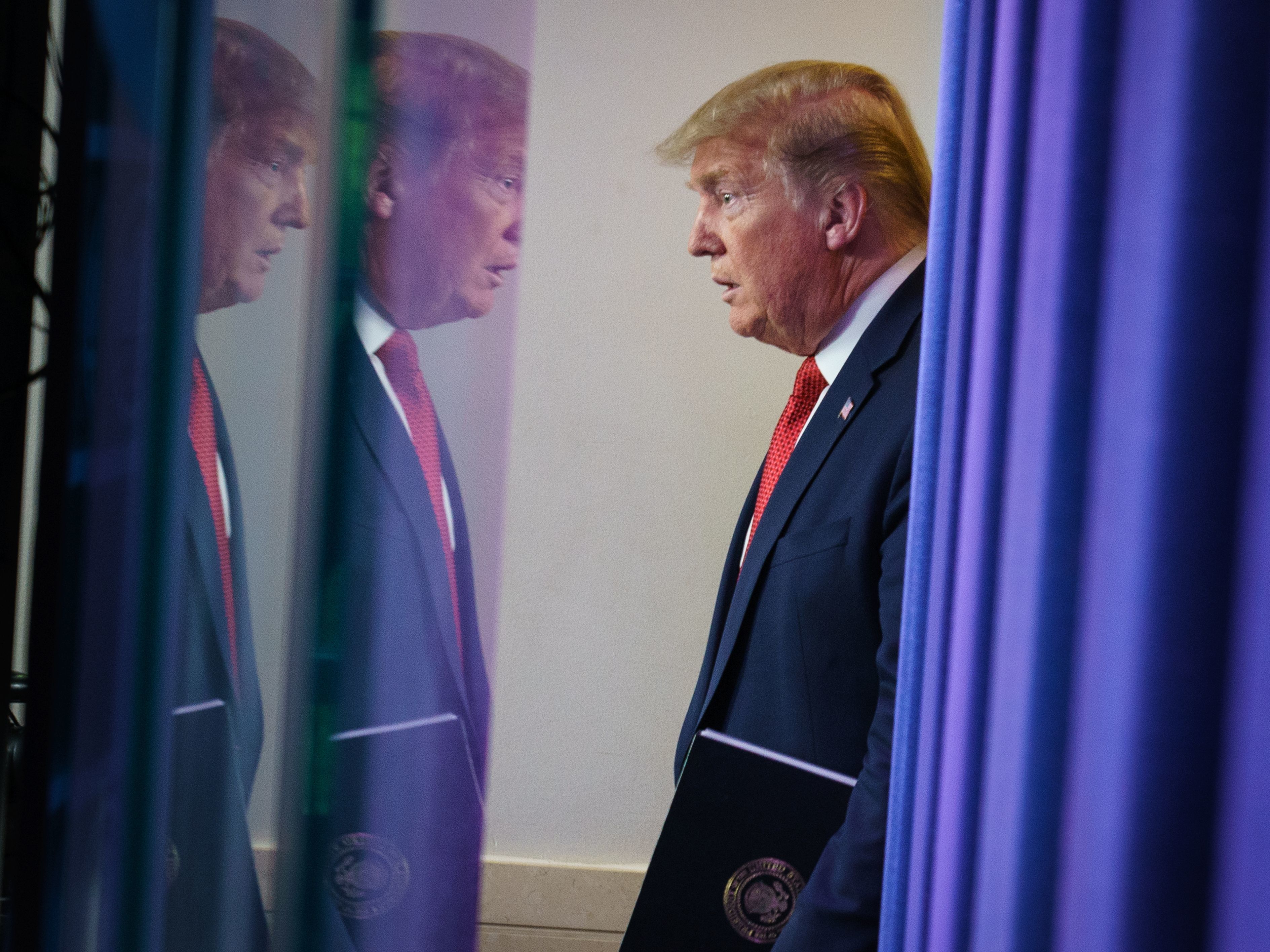 caption: President Trump arrives for the coronavirus task force briefing at the White House on Thursday.