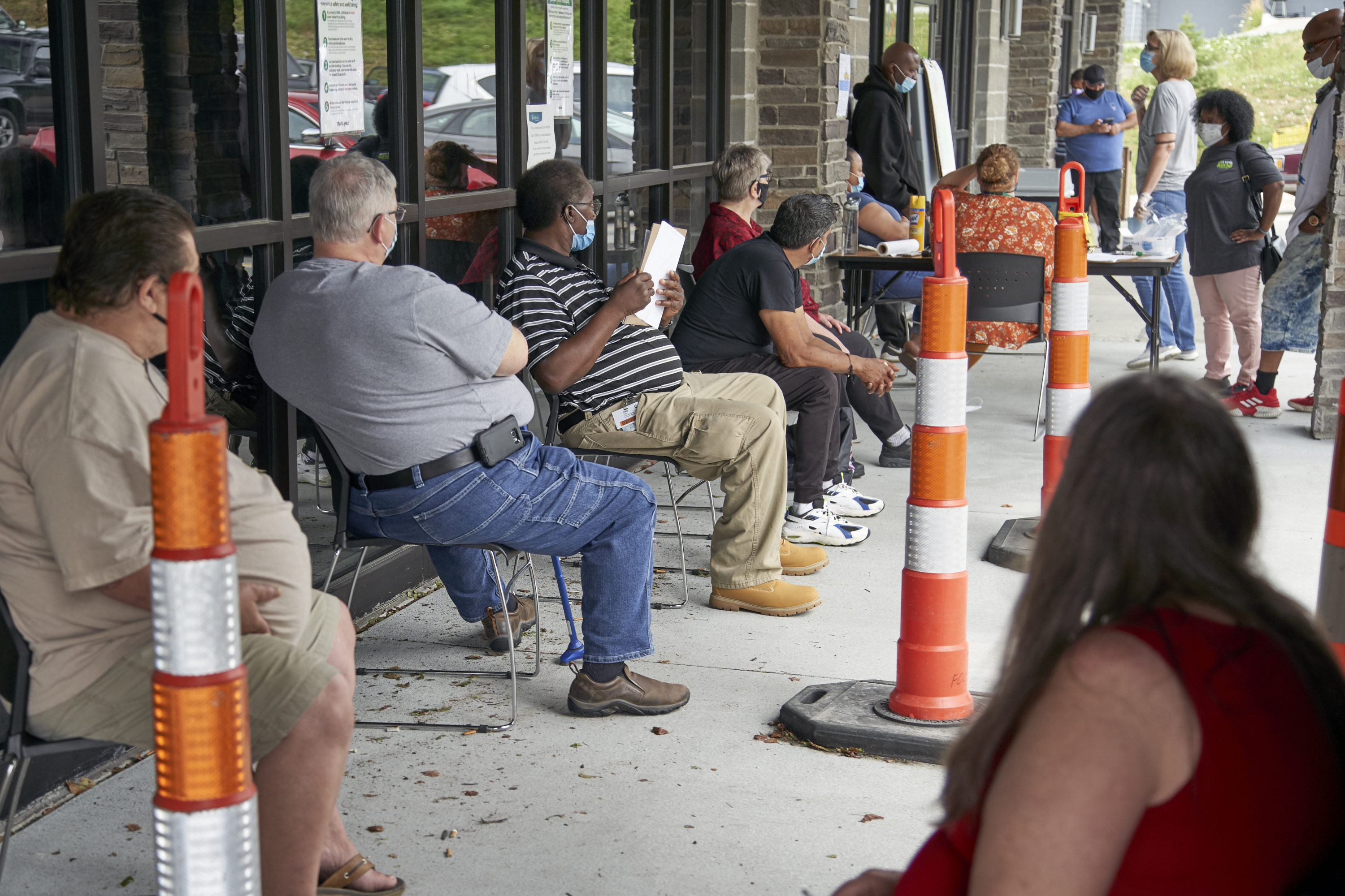 caption: Job seekers exercise social distancing as they wait to be called into the Heartland Workforce Solutions office in Omaha, Neb., July 15, 2020. (Nati Harnik/AP)