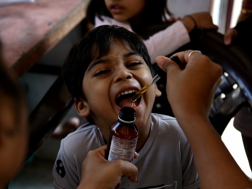 caption: A health worker administers a measles vaccine during a vaccination drive, prompted by a measles outbreak, in Navi Mumbai, India, in December 2022. A new UNICEF report finds that India has the world's largest number of children with zero doses of childhood vaccines: 2.7 million