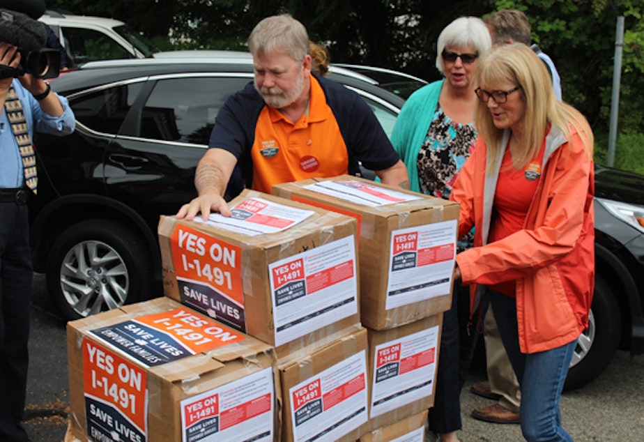 caption: I-1491 supporters deliver signatures in Olympia on Thursday.
