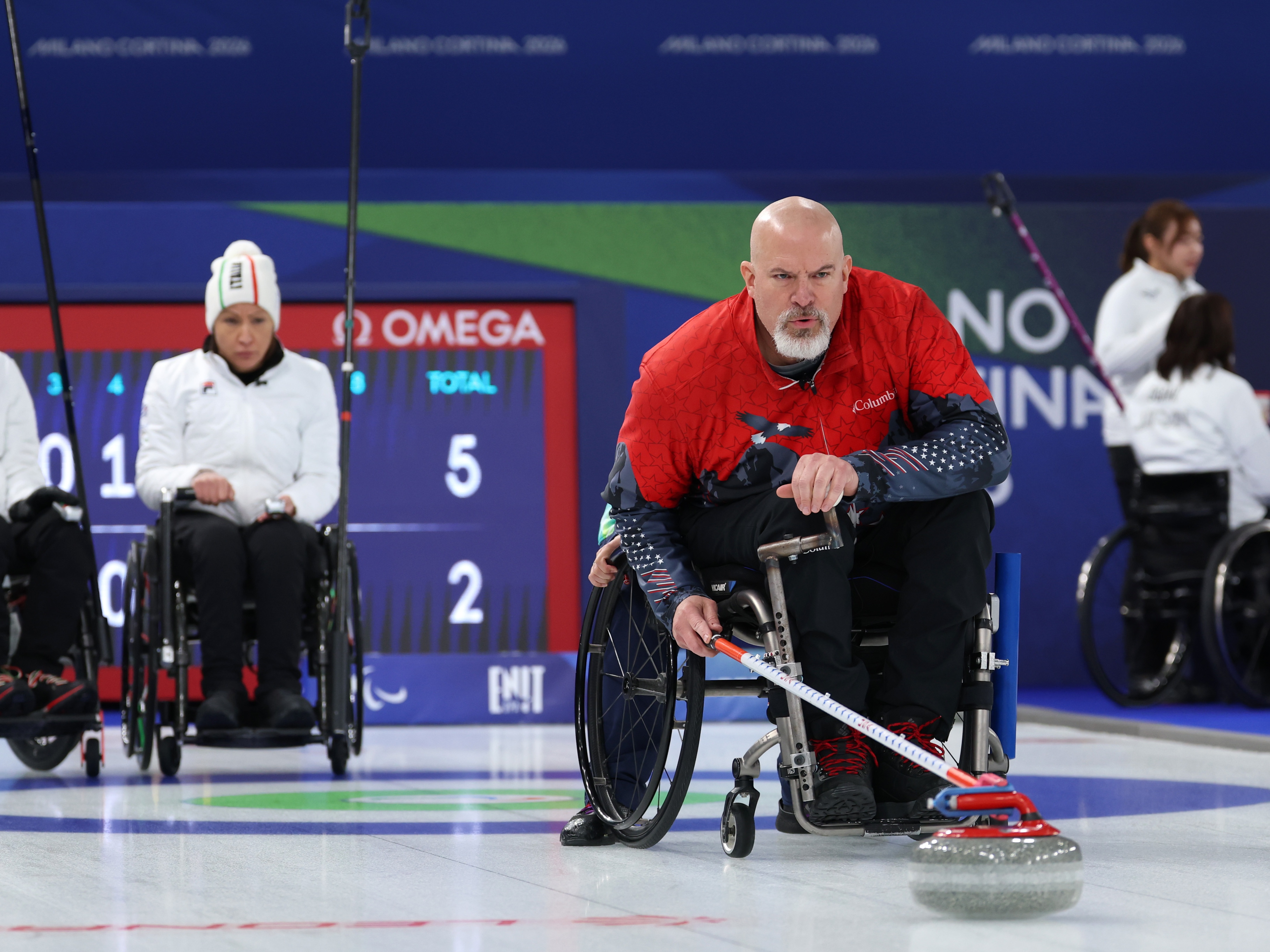 caption: American Steve Emt competes in Sunday's mixed doubles match against Italy, which the U.S. won.