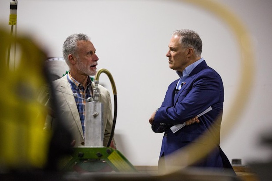 caption: Presidential hopeful and Washington Gov. Jay Inslee, right, speaks with International Brotherhood of Electrical Workers Local 48 business manager Gary Young at the IBEW training center in Portland, Ore., Saturday, March 23, 2019. Inslee is visiting cities across the country as part of the Climate Mission Tour in the early stages of his presidential compaign.