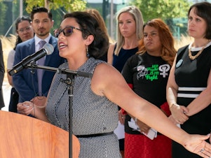 caption: Elizabeth Weller speaks at a press conference in Austin, Texas on July 19. She's one of 20 women suing the state after being denied abortions despite serious pregnancy complications.