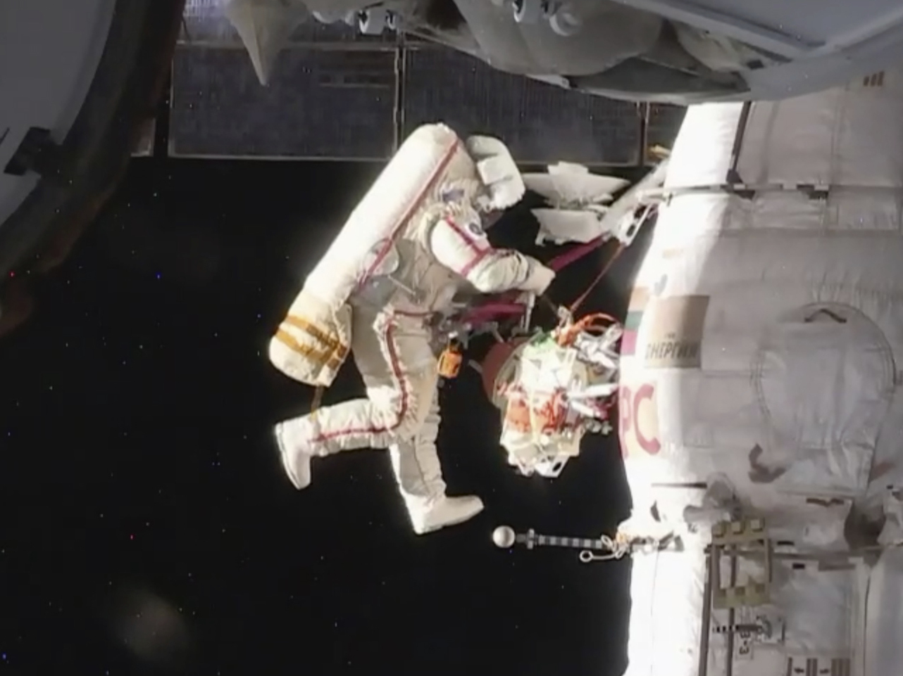 caption: Russian cosmonaut Oleg Kononenko performs a spacewalk outside the International Space Station on Tuesday. Kononenko and Sergey Prokopyev are inspecting a section where a mysterious leak appeared on Aug. 30.