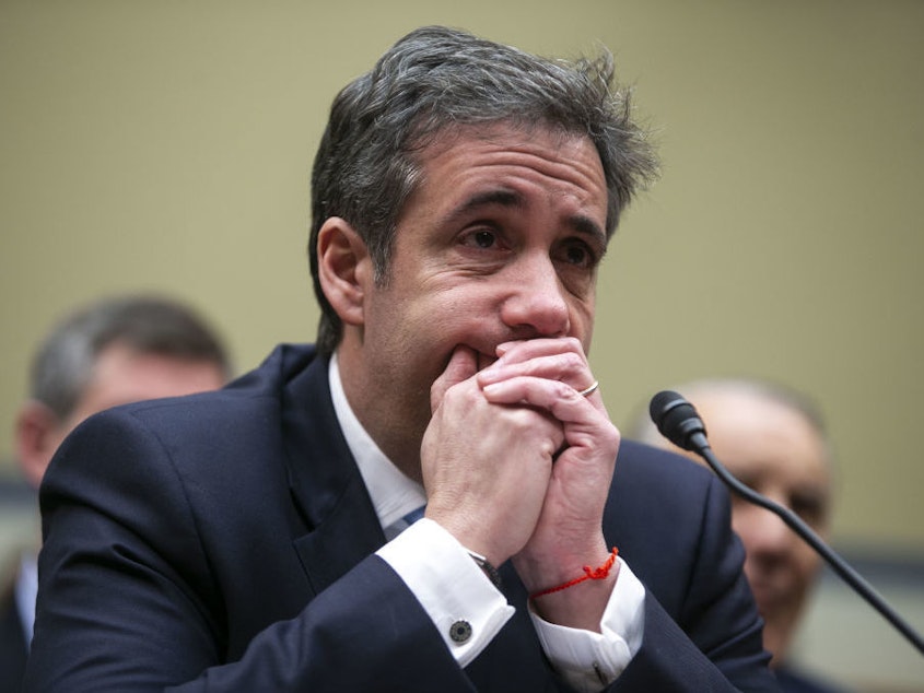 caption: Michael Cohen, former personal lawyer to President Trump, listens to closing statements during a House Oversight Committee hearing in February 2019.