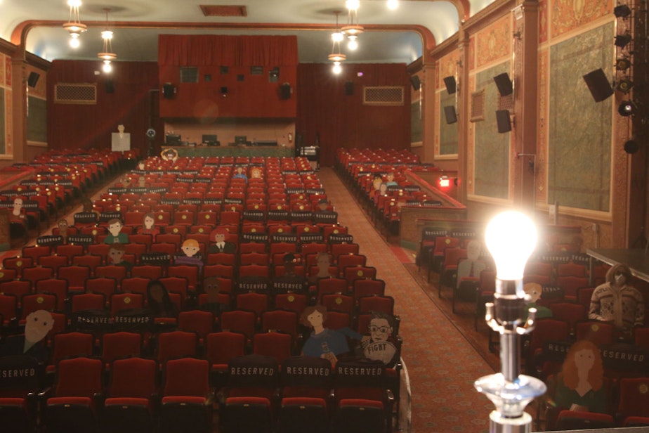 caption: A ghost light illuminates the empty stage at the Lincoln Theater in Mount Vernon Washington.