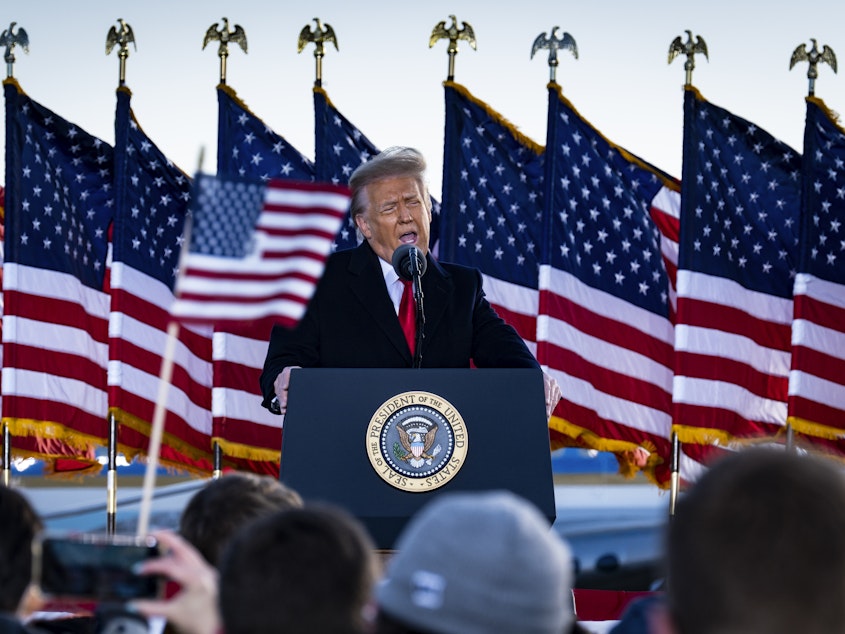 caption: Former President Donald Trump, seen here speaking to supporters on Jan. 20, attacked Senate Minority Leader Mitch McConnell in a statement Tuesday evening.