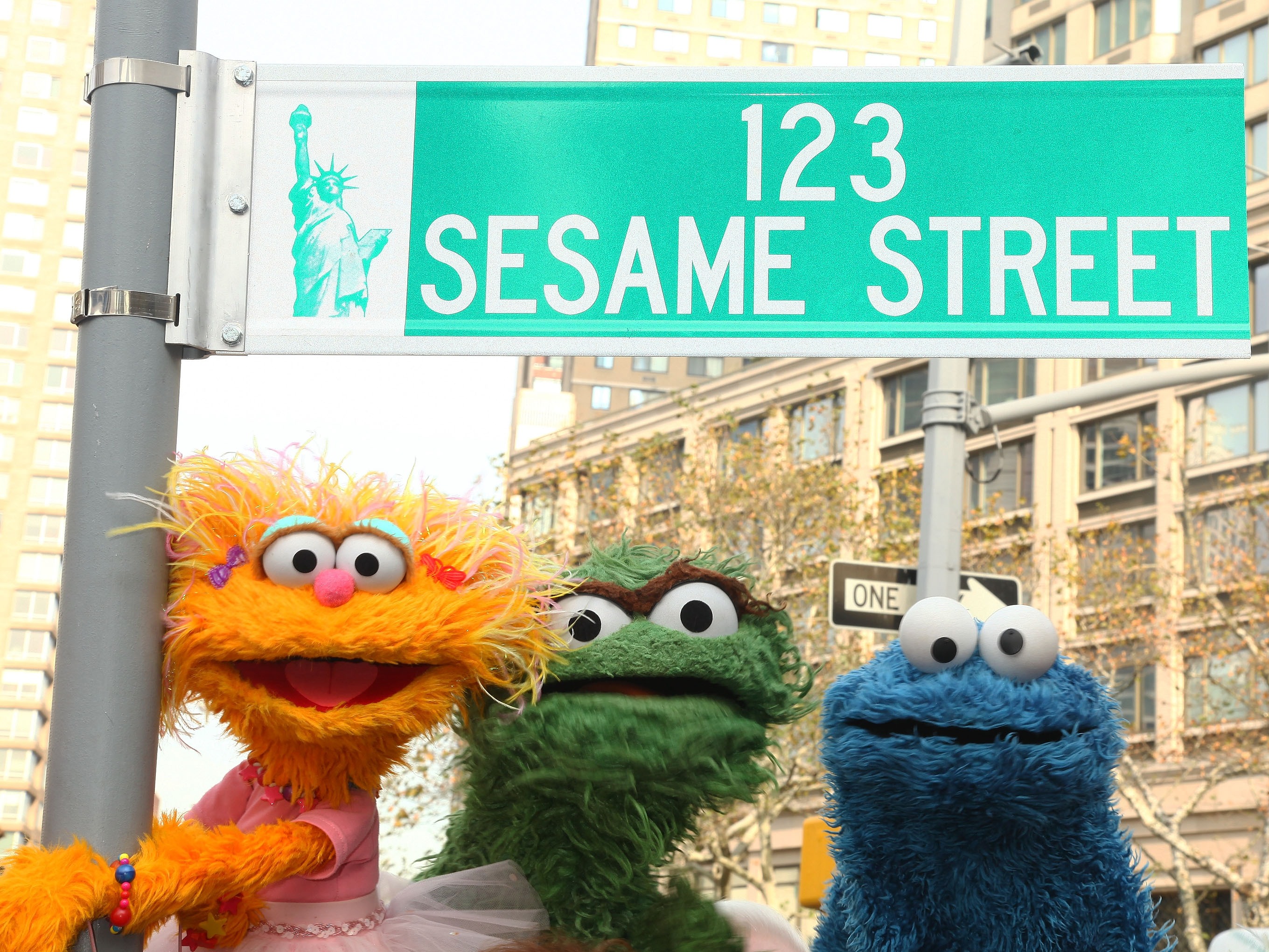caption: <em>Sesame Street</em> characters pose under a "123 Sesame Street" sign in celebration of their 40th anniversary in 2009.