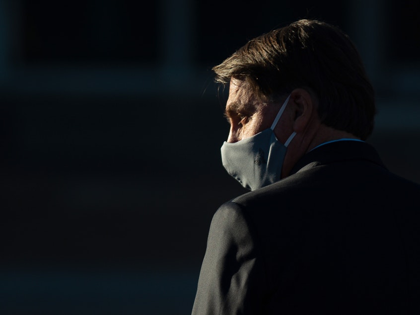 caption: Brazilian President Jair Bolsonaro, seen during a ceremony last month in Brasilia, has announced his coronavirus test results.