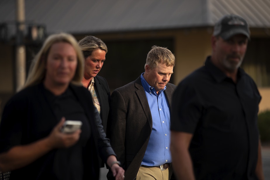 caption: Cody Easterday walks with family members from the Federal Courthouse on South Third Street after being sentenced to 11 years, on Tuesday, October 4, 2022, in Yakima.