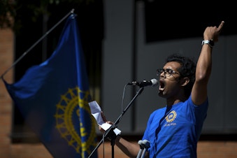 caption: Sourojit Ghosh, PhD candidate at the University of Washington, speaks to a crowd gathered ahead of the UW Board of Regents meeting on Thursday, May 9, 2024,  in Seattle. Academic Student Employees went on strike on Tuesday, May 14, 2024. 