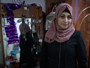 caption: Rimah Shahada poses in her daughter Aseel's bedroom in Qalandiya refugee camp in Ramallah, West Bank Nov. 22.