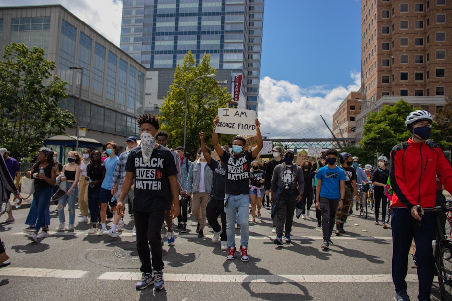 caption: Trey Rudolph leads an Eastside Change Coalition march through Bellevue this summer.