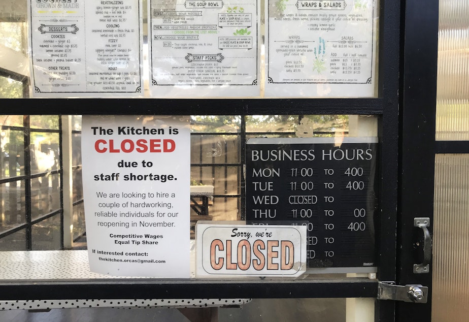 caption: A sign indicates that The Kitchen, a restaurant in Eastsound, is closed due to a staff shortage, on Saturday, September 25, 2021, on Orcas Island. 