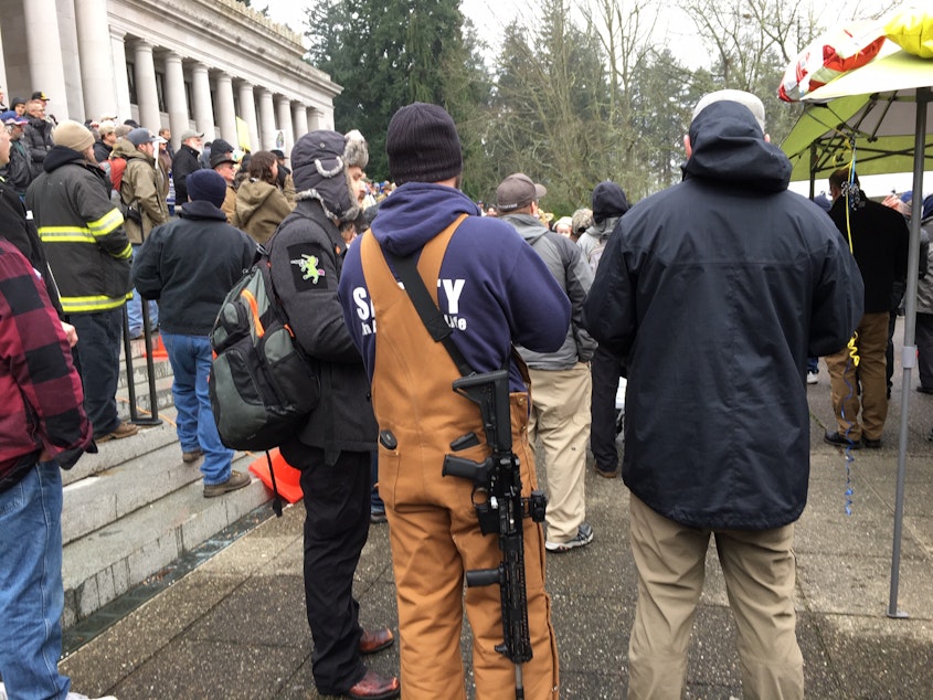 caption: Under current Washington law, visitors to the Capitol can openly-carry firearms. A bill introduced in the Legislature would ban weapons from the statehouse and Capitol grounds. 