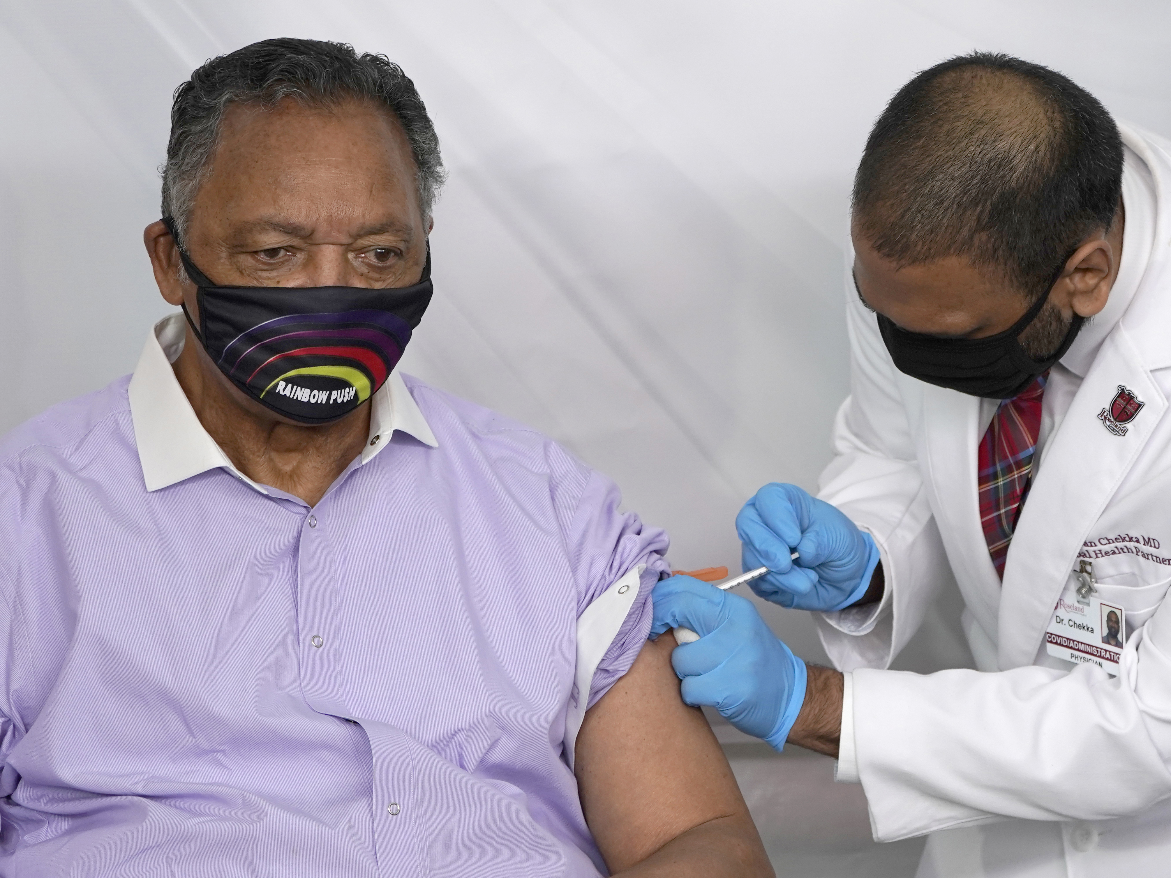 caption: Rev. Jesse Jackson, shown receiving the Pfizer-BioNTech COVID-19 vaccine in January, and his wife, Jacqueline, have been hospitalized after testing positive for COVID-19.
