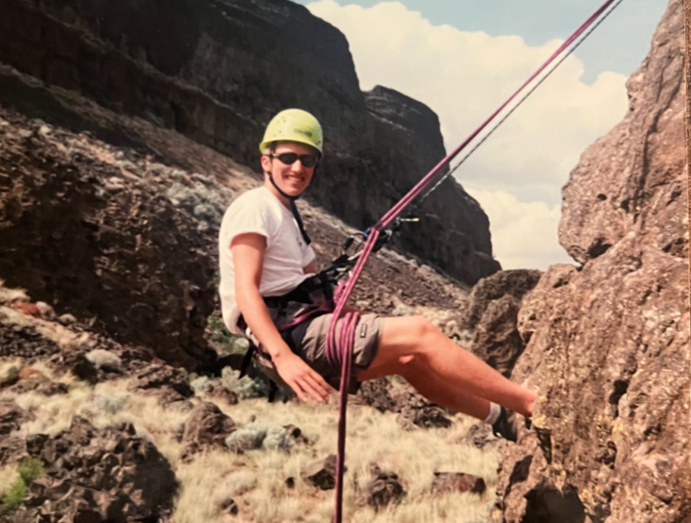caption: Jonathan Hill, Garfield High School class of 2000, rock climbs at Post 84's Desert School in spring 2000, soon after the program's leader died by suicide.