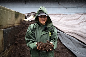 caption: Liv Johansson, sustainable waste management specialist for Woodland Park Zoo, holds composted ‘zoo doo’ on Wednesday, September 27, 2023, in the ‘doo yard’ at the Woodland Park Zoo in Seattle. 