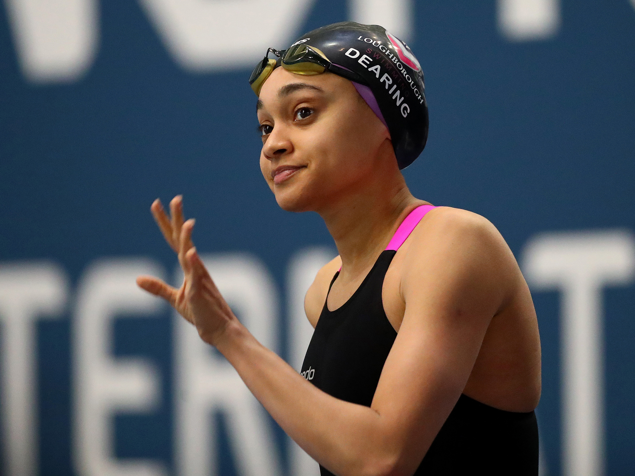 caption: Alice Dearing, who is slated to become the first ever Black woman to represent Great Britain in swimming at the Olympics this year, is an ambassador for Soul Cap, a swim cap made for natural Black hair.