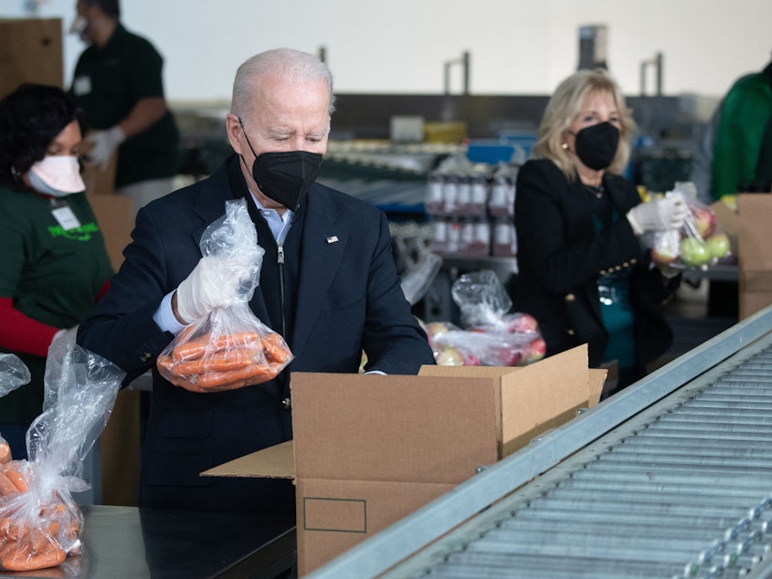 caption: President Biden and first lady Jill Biden pack food boxes while volunteering on Martin Luther King, Jr., Day of Service in Philadelphia, Pennsylvania on Jan. 16, 2022.
