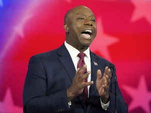 caption: Republican presidential candidate Sen. Tim Scott, R-S.C., speaks during a Republican presidential primary debate hosted by NBC News on Nov. 8. Just 4 days later, Scott announced he is suspending his bid for the White House in an interview on Fox News.