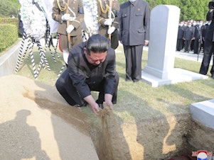 caption: In this photo provided by the North Korean government, North Korean leader Kim Jong Un covers the coffin of Hyon Chol Hae, marshal of the Korean People's Army, with earth at a cemetery in Pyongyang, North Korea Sunday, May 22, 2022. The content of this image cannot be independently verified.