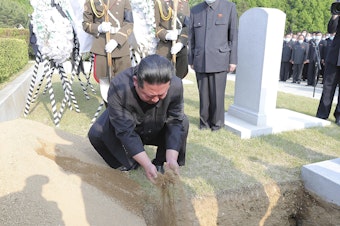 caption: In this photo provided by the North Korean government, North Korean leader Kim Jong Un covers the coffin of Hyon Chol Hae, marshal of the Korean People's Army, with earth at a cemetery in Pyongyang, North Korea Sunday, May 22, 2022. The content of this image cannot be independently verified.