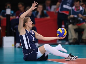 caption: Lora Webster of The United States plays a shot during the Women's Sitting Volleyball final Gold Medal match at the London 2012 Paralympic Games. She'll be competing in Tokyo this year.
