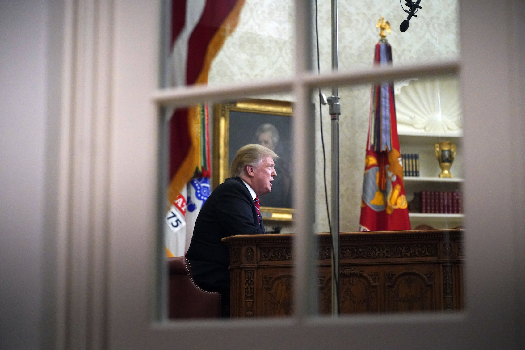 caption: President Donald Trump addresses the nation from the Oval Office of the White House in Washington, Tuesday, Jan. 8, 2019. (Carolyn Kaster/AP)