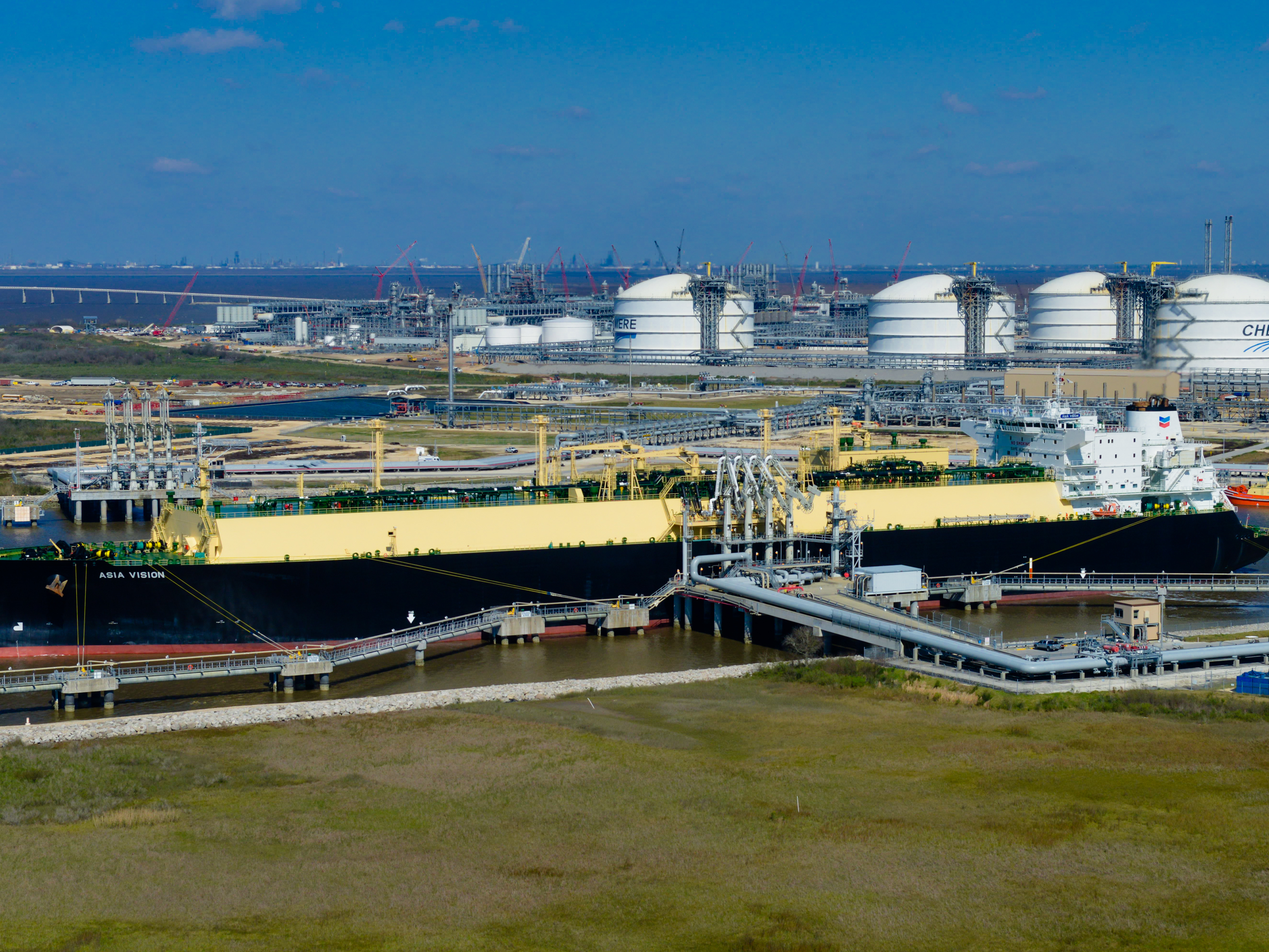 caption: The Asia Vision LNG carrier ship sits docked at the Cheniere Energy Inc. terminal in this aerial photograph taken over Sabine Pass, Texas in 2016.