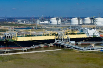 caption: The Asia Vision LNG carrier ship sits docked at the Cheniere Energy Inc. terminal in this aerial photograph taken over Sabine Pass, Texas in 2016.
