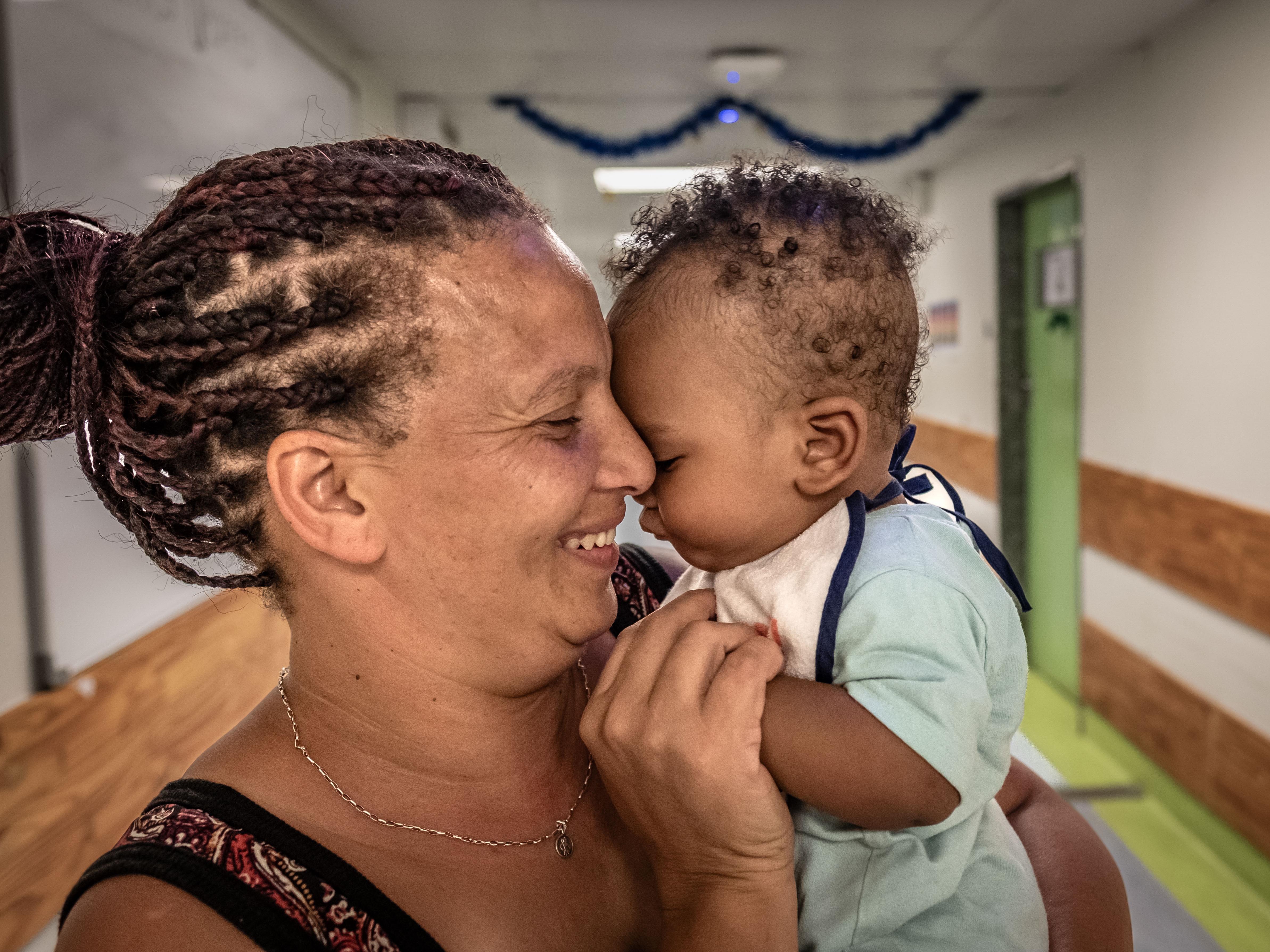 caption: "For me, a baby is a blessing," says Abigail Hendricks, who benefited from a new drug trial for preeclampsia. Here she is with her almost 9-month-old, Hayden