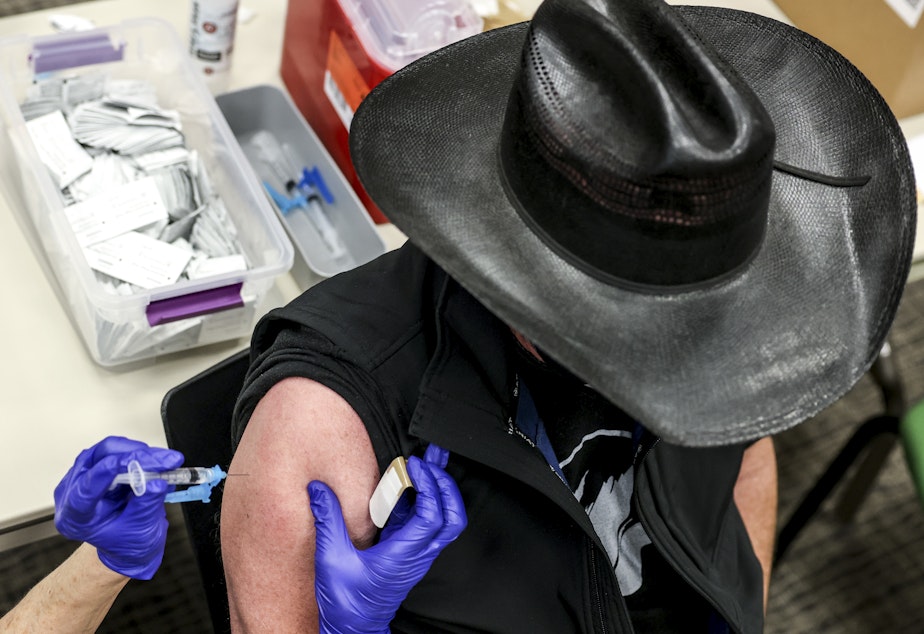 caption: Colorado's UCHealth hospital system is requiring any prospective organ transplant recipients to get the COVID-19 vaccine. Here, a man receives a COVID-19 vaccine in Thornton, Colo., earlier this year.