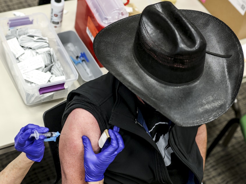 caption: Colorado's UCHealth hospital system is requiring any prospective organ transplant recipients to get the COVID-19 vaccine. Here, a man receives a COVID-19 vaccine in Thornton, Colo., earlier this year.