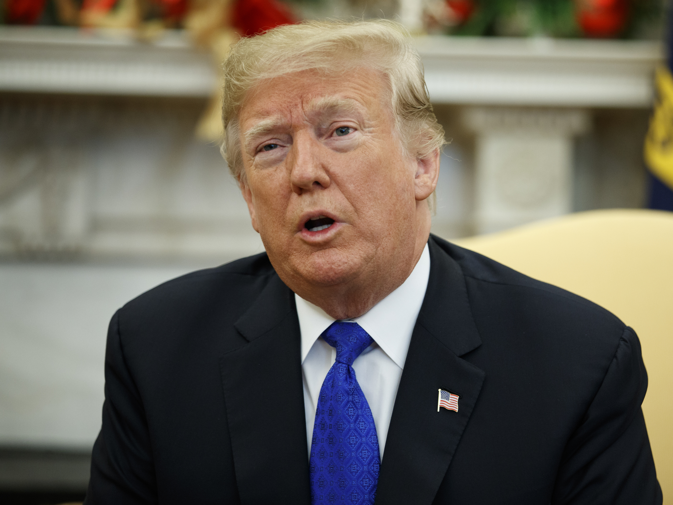 caption: President Trump speaks during a meeting with Democratic congressional leaders in the Oval Office on Tuesday.