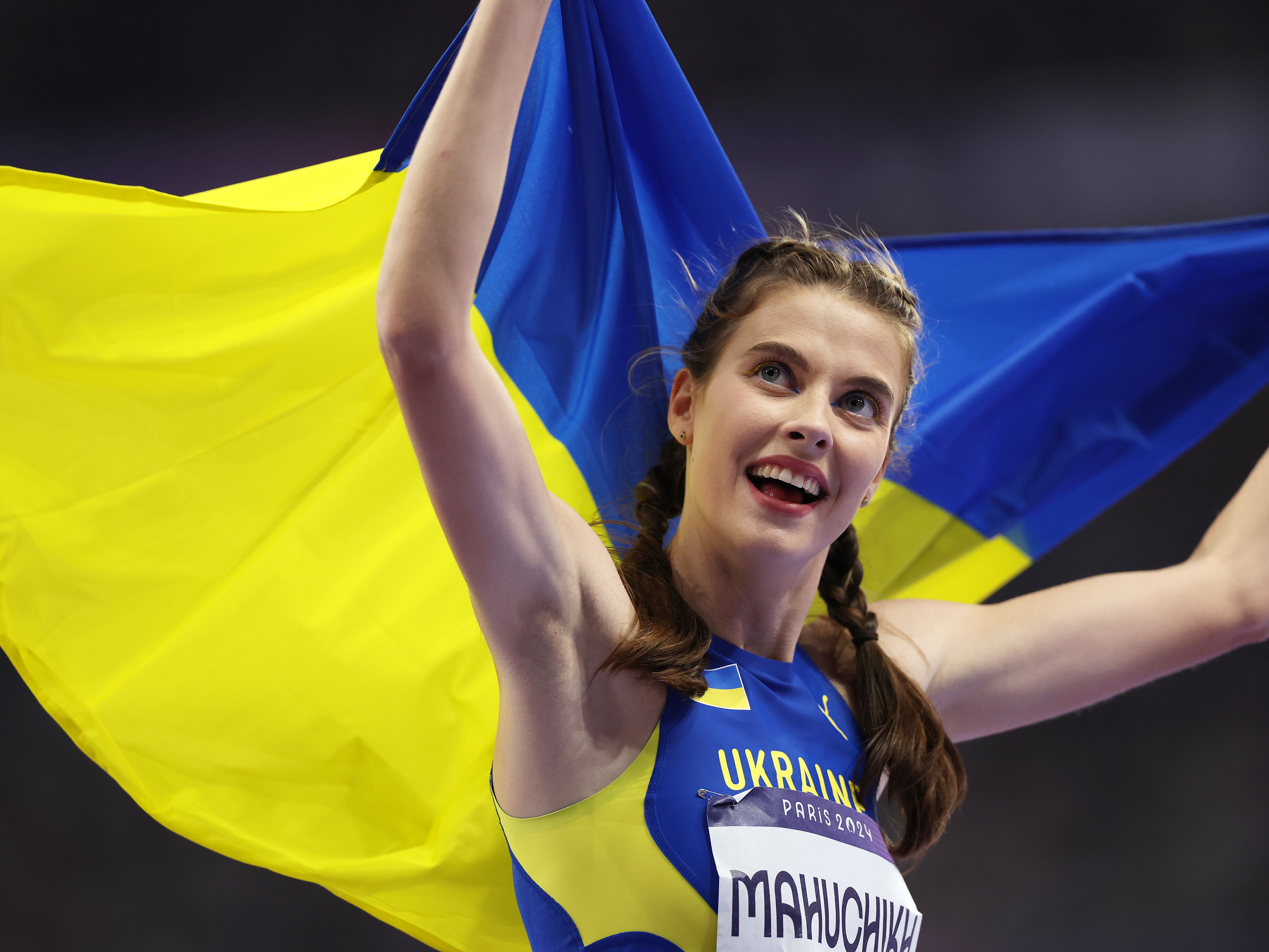 caption: Gold medalist Yaroslava Mahuchikh celebrates her win in the women's high jump final at the Paris Olympic Games, on a day when Ukraine won three medals. Ukrainian athletes are dedicating their victories to the Ukrainian people who face a grinding invasion by Russia.