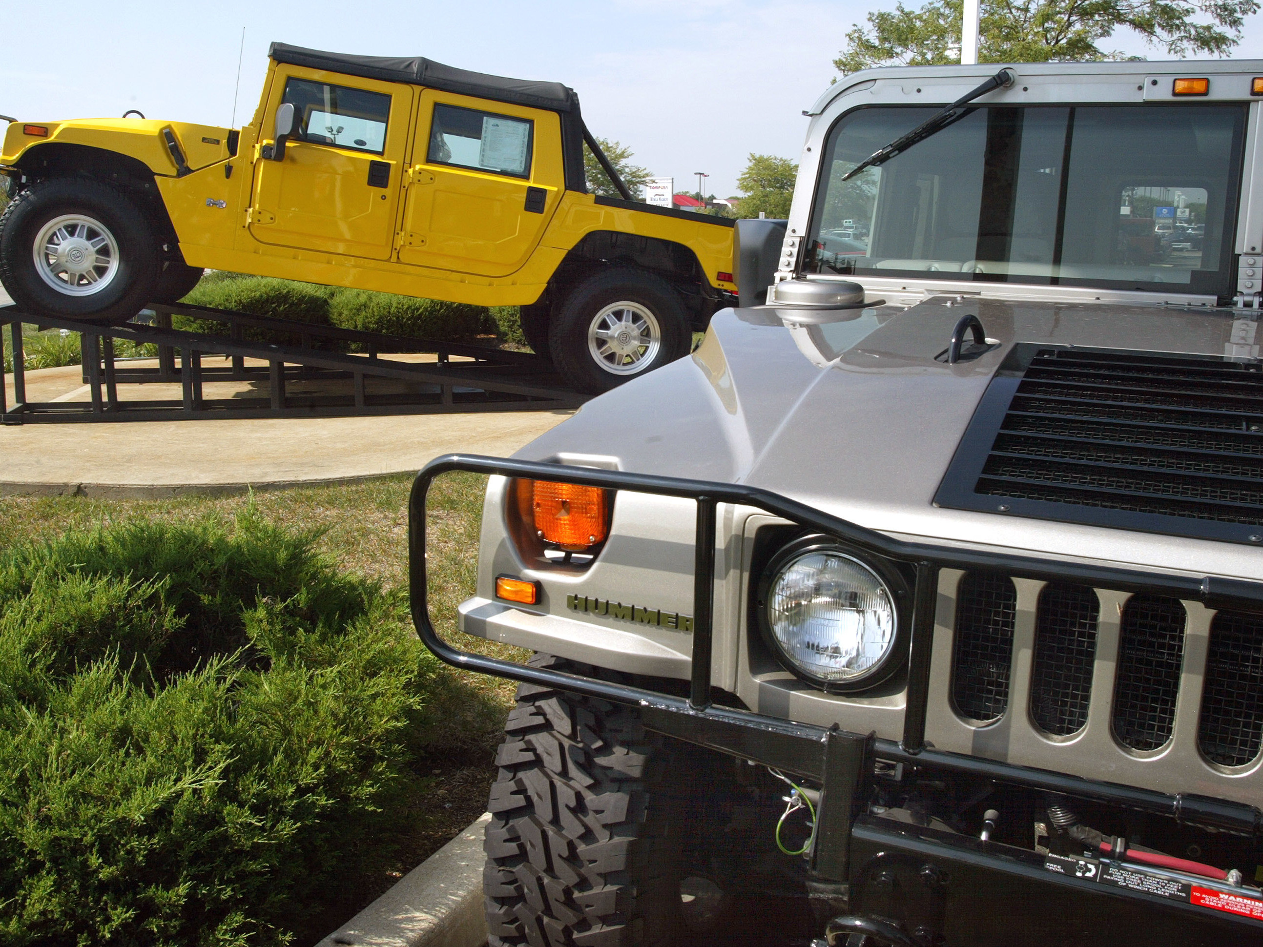 caption: Hummer SUVs are displayed at a dealer in Schaumburg, Ill., in 2002.